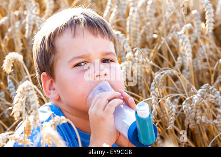 Junge mit Inhalator für Asthma im Dorf mit Sommer Sonnenuntergang Stockfoto