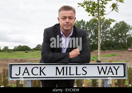 Crewe, Cheshire, UK. 27. Juli 2015. Ian Mills stützt sich auf das Zeichen für die neue Basford West Wirbelsäule Straße in Crewe. Es ist Jack Mills Weg nach seinem Großvater, der späten lokalen Lokführer benannt, während die Great Train Robbery 1963 angegriffen wurde. Bildnachweis: Michael Buddle/Alamy Live-Nachrichten Stockfoto