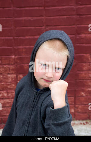 Kinder kämpfen in der Nähe von Mauer Stockfoto