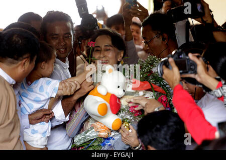 Yangon, Myanmar. 29. Juli 2015. Führer der Myanmars Nationalliga für Demokratie (NLD) Aung San Suu Kyi (C) erhält Blumen von einem Kind nach ihrer Bewerbung für den bevorstehenden MultiPartei Wahlen am 8. November an der südlichen Yangon Bezirk Wahlkommission in den Stadtrand von Yangon, Myanmar, 29. Juli 2015 geplant laufen. Bildnachweis: U Aung/Xinhua/Alamy Live-Nachrichten Stockfoto