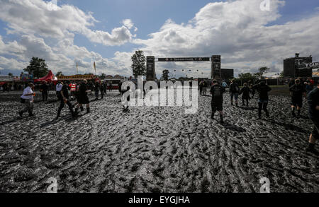 Wacken, Deutschland. 29. Juli 2015. Besucher von W.O.A (Wacken Open Air) zu Fuß durch den Schlamm auf dem Festivalgelände in Wacken, Deutschland, 29. Juli 2015. Heavy-Metal-Fans aus der ganzen Welt kommen nach Wacken zum größten Heavy-Metal-Festival der Welt zu feiern. Bildnachweis: Dpa picture Alliance/Alamy Live News Stockfoto