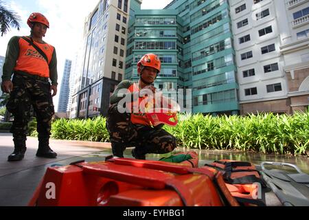 Quezon City, Philippinen. 30. Juli 2015. Ein Rettungskräfte bereitet seine Ausrüstung vor das bundesweite Erdbeben Bohren in Libis. Der Bohrer wird basierend auf eine Projektion von einem 7.2 Erdbeben erzeugt durch die Bewegung der West Valley Fehler gemacht. Bildnachweis: Mark Cristino/Pacific Press/Alamy Live-Nachrichten Stockfoto