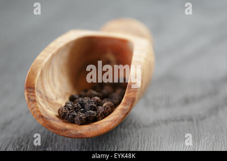 schwarzer Pfeffer im Olivenöl Schaufel auf Holztisch Stockfoto