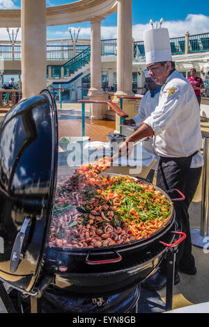 CHEFKOCH MEERESFRÜCHTE & PASTA, "NORWEGIAN SPIRIT" - CA. APRIL 2015.  ein Koch mischt, Fisch- und Nudelgerichte in einem großen Kessel Stil B Stockfoto