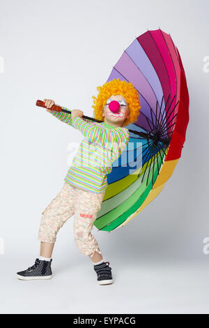 Clown mit bunten Regenschirm auf weiß Stockfoto