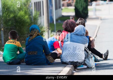 Suhl, Deutschland. 3. August 2015. Bewohner von der Flüchtlings-Auffanglager sitzen an der Seite einer Straße in Suhl, Deutschland, 3. August 2015. Das deutsche Bundesland Thüringen sucht dringend weitere Eigenschaft, die Flüchtlinge unterzubringen. Foto: Sebastian Kahnert/Dpa/Alamy Live News Stockfoto