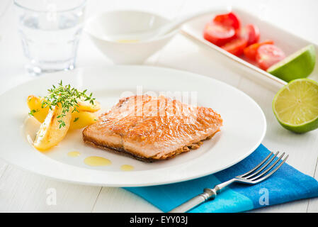 Gegrillter Lachs mit Bratkartoffeln auf dem Silbertablett serviert. Stockfoto