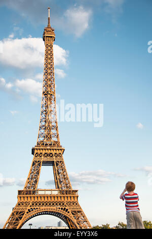 Kaukasische junge Eiffelturm zu bewundern, unter blauem Himmel, Paris, Ile de France, Frankreich Stockfoto