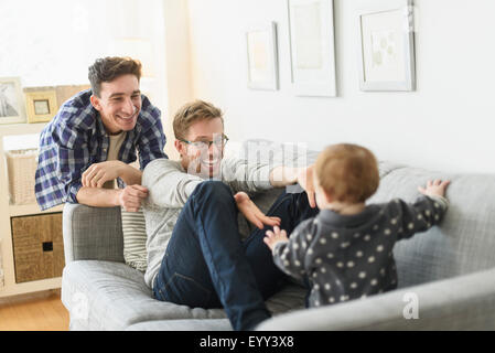 Kaukasische Schwule Väter und Baby entspannend auf sofa Stockfoto
