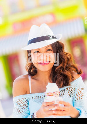 Chinesische Frau essen Eiscreme-Kegel Stockfoto