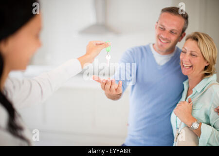 Grundstücksmakler, die paar Schlüssel in neues Zuhause Stockfoto