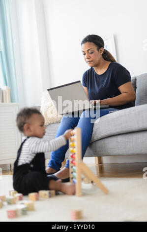 Gemischte Rennen Mutter und Baby Sohn im Wohnzimmer entspannen Stockfoto