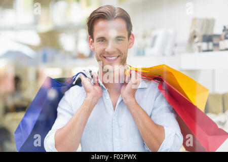 Porträt eines lächelnden Menschen mit Einkaufstüten Stockfoto