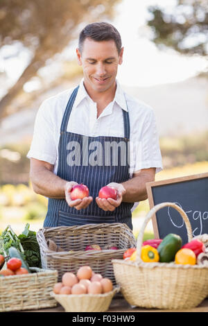 Lächelnde Bauern halten zwei rote Äpfel Stockfoto