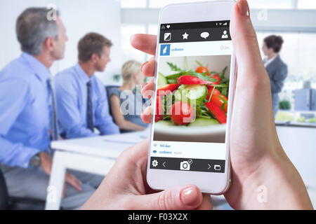 Zusammengesetztes Bild von Hand mit smartphone Stockfoto