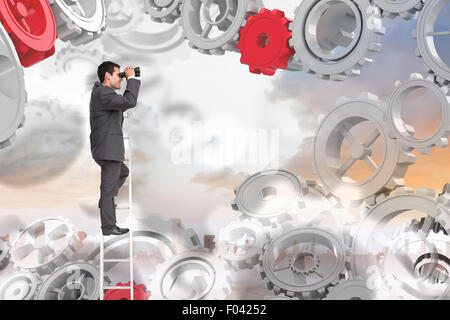 Zusammengesetztes Bild der Geschäftsmann auf Leiter stehend Stockfoto