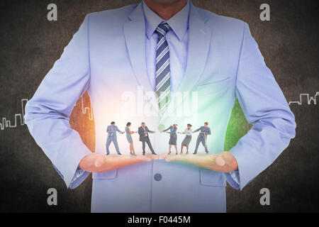 Zusammengesetztes Bild Business Teams ziehen das Seil Stockfoto