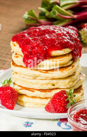 Stapel von Pfannkuchen auf Teller mit Erdbeer-Rhabarber-Marmelade Stockfoto