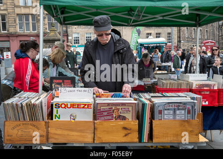 Ein Kunde durchsucht die Regale von Vinyl-Schallplatten auf einen Stall in der Grassmarket, Edinburgh, Schottland, Vereinigtes Königreich. Stockfoto