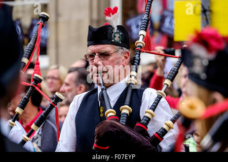 Eine Piper spielt auf Pipefest 2015 - Massed Pipe Bands März auf der Royal Mile in Edinburgh während des Festivals 2015 Stockfoto