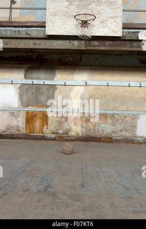 Basketball am Hof unter Rückwand und Net in Old-School-Gymnasium. Stockfoto