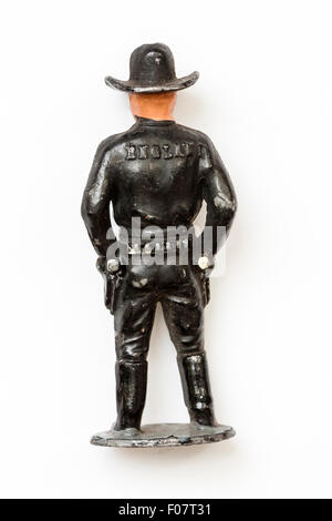 Halbmond ca. 50er Metall führen Timpo cowboy Figur. Stehend, schwarz gekleidet, über Waffen zu ziehen. Hopalong Cassidy. Weißem Hintergrund. Zurück. Stockfoto