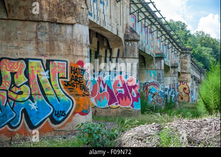 Unterstützt das Graffiti bedeckt auf einer alten Brücke in Asheville, North Carolina Fluss Arts District. USA. Stockfoto