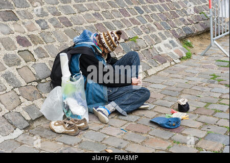 PARIS, Frankreich - 27. Juli 2015: Ein Obdachloser sitzt und betteln um Geld auf einer Straße in Paris in Frankreich Stockfoto