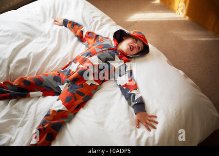 Junge auf Bett liegend Stockfoto