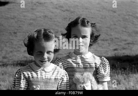 Zwei junge Mädchen im Sommer Kleider stehen in einem Garten. Stockfoto