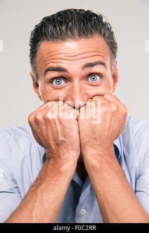 Porträt eines verängstigten Blick in die Kamera auf einem weißen Hintergrund isoliert Stockfoto