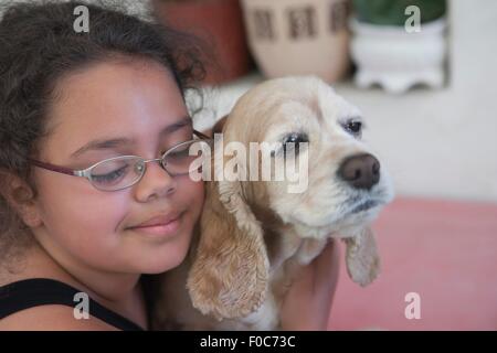 Junges Mädchen umarmt Hund, Nahaufnahme Stockfoto