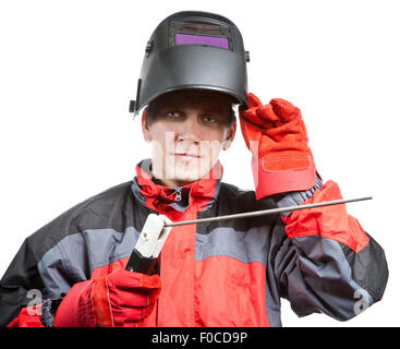 Der Mann in Arbeitskleidung und eine Maske des Schweißers Stockfoto