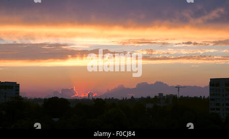 Sonnenuntergang in Wolken über Stadtbild Stockfoto