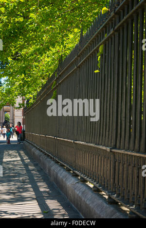 London Southbank Greenwich University Metall Eisen Stahl schwarz Geländer Dame female Mädchen Frau rote Brücke zu Fuß Stockfoto