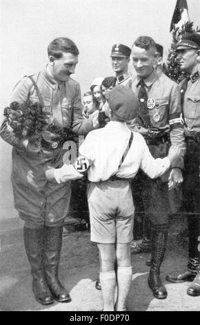 Hitler, Adolf, 20.4.1889 - 30.4.1945, deutscher Politiker (NSDAP), Reichskanzler 30.1.1933 - 30.4.1945, während eines Wahlkampfes, wird von einem Mitglied der Jungvolk, 1933, begrüßt. Stockfoto