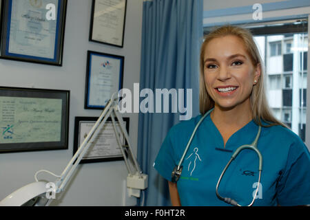 Eine junge Ärztin erwartet ihre Patienten in ihrer Praxis. Stockfoto