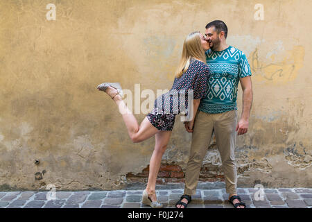 Glückliches junges Paar in Liebe Spaß gegen die Wand des Hauses. Stockfoto