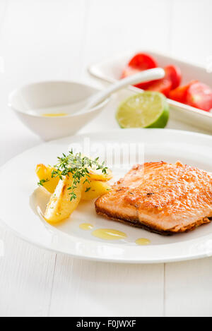 Gegrillter Lachs mit Bratkartoffeln auf dem Silbertablett serviert. Stockfoto