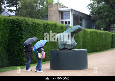 Wakefield, UK. 18. August 2015. Ein paar Schutz vor dem Regen unter ihrem Dach bei einem Besuch in Yorkshire Sculpture Park in der Nähe von Wakefield, West Yorkshire. Bild: Scott Bairstow/Alamy Live-Nachrichten Stockfoto