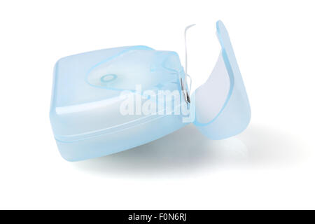 Zahnseide in Plastikbehälter auf weißem Hintergrund Stockfoto