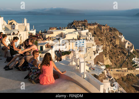 Touristen versammeln, um Uhr Sonnenuntergang von Kastelli (Burg) von Agios Nikolaos in Oia, Santorini, Griechenland Stockfoto