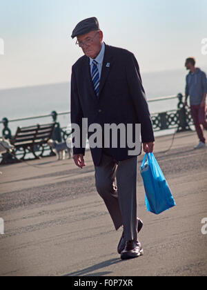 Ein älterer Mann führt ein Spaziergang entlang der Promenade in Hove, Brighton Stockfoto