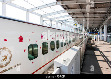 Japan, Shin-Tosu. Serie 800, Tsubame service Skinkansen, Bullet Train. Schlitten mit rosa Kirschblüten Schablonen eingerichtet. Stockfoto