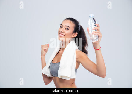 Porträt einer Frau fröhlich Sport mit Handtuch hält die Flasche mit Wasser isoliert auf weißem Hintergrund Stockfoto