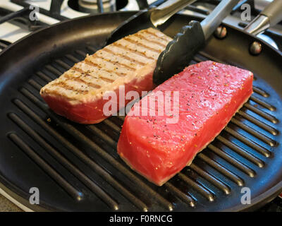 Sushi-Grade rohen Thunfisch Steaks Kochen am Herd Grill Pan Stockfoto