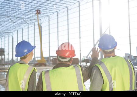 Rückansicht des Surveyor und Bauherren treffen auf Baustelle Stockfoto