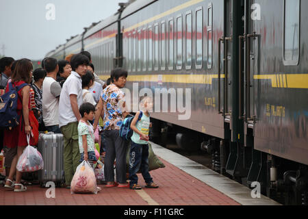 Weihai, China Shandong Provinz. 25. August 2015. Kinder vorbereiten, auf einen Zug Heimatstadt nach einem Familientreffen in den Sommerferien am Bahnhof Wendung in Weihai, Ost-China Shandong Provinz, 25. August 2015 zurückgehen. Viele chinesische Kinder, die gelassen werden, um ihre Verwandten am Heimatort zur Schule zu gehen, da ihre Eltern arbeiten, um Geld in anderen Städten müssen zu leben, wählen Sie wieder zusammen mit ihren Eltern im Winter und Sommer Urlaub. © Chen Hongqing/Xinhua/Alamy Live-Nachrichten Stockfoto