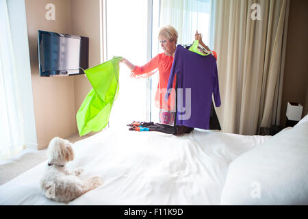 Ältere Frau kaukasischen Wahl Outfit im Schlafzimmer Stockfoto