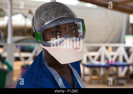 Ein Healthcare Arbeiter Kleider in Schutzkleidung vor der Überschrift in die rote Zone von einem Ebola-Behandlungseinheit 9. Januar 2015 in N'zerekore. Stockfoto